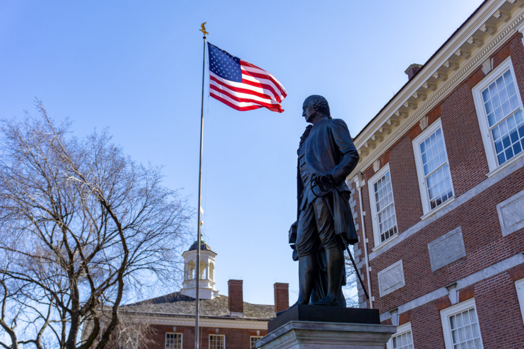Statue of George Washington with the American flag at Independence Hall.
