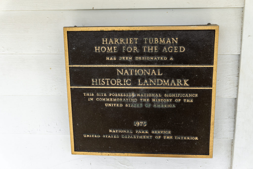 "National Historic Landmark" plaque on the exterior wall of the Harriet Tubman Home for the Aged.