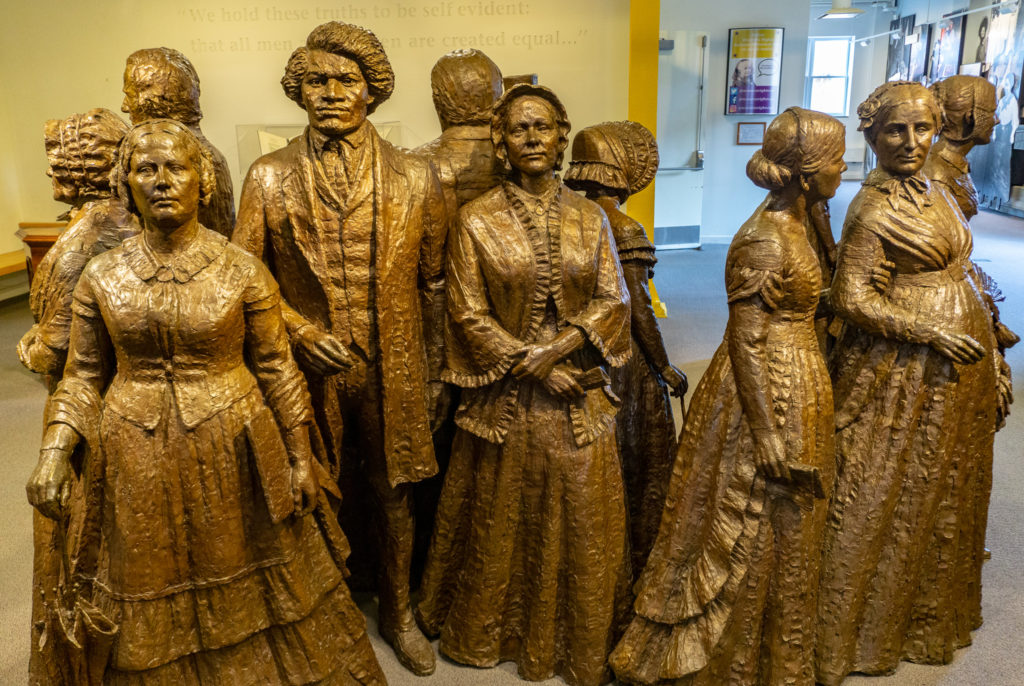 The many faces of "The First Wave" statue exhibit inside the Women's Rights National Historical Park Visitor Center.